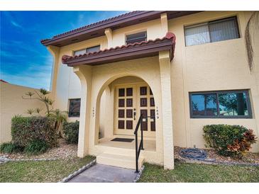 Inviting condo building exterior with lush landscaping and Spanish-style architecture at 1437 57Th W St # 1437, Bradenton, FL 34209