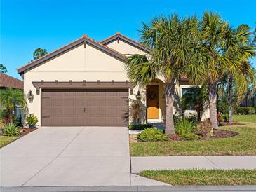 Single-story home with brown garage door, landscaping, and palm trees at 224 Ariano Ave, Nokomis, FL 34275