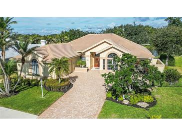 Luxury home with tile roof, paver driveway & lush landscaping at 256 Royal Oak Way, Venice, FL 34292