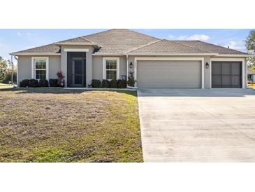 Single-story house with attached garage and landscaping at 2949 Jaylene Rd, North Port, FL 34288