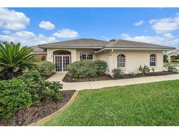 Well-maintained house with a landscaped lawn and walkway at 538 Laurel Cherry Ln, Venice, FL 34293