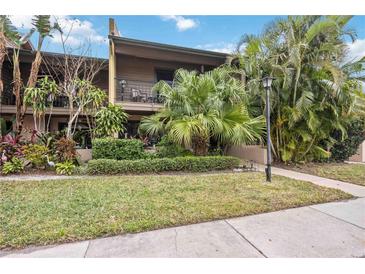 Front view of condo with landscaping and walkway at 958 Sunridge Dr # H3, Sarasota, FL 34234