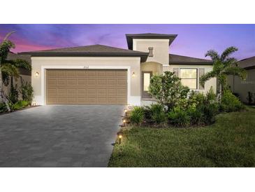 One-story home with attractive landscaping and a two-car garage at 1932 W Isles Rd, Port Charlotte, FL 33953