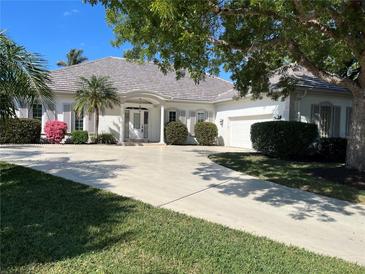 One-story home with tile roof, shutters, and landscaped yard at 20 Saint Croix Way, Englewood, FL 34223