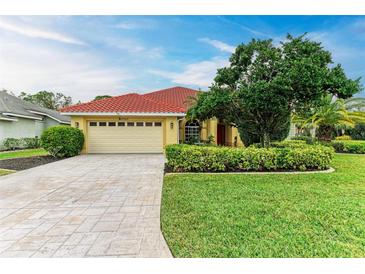 Beautiful one-story home with a tile roof, and well-manicured lawn at 7023 Chickasaw Bayou Rd, Bradenton, FL 34203