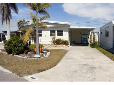 Single-story home with covered carport, landscaping, and paved driveway at 808 S Green Cir, Venice, FL 34285