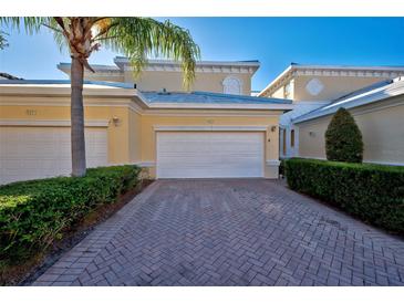 Front view of charming villa with two-car garage and landscaped entry at 901 Triano Cir # 901, Venice, FL 34292