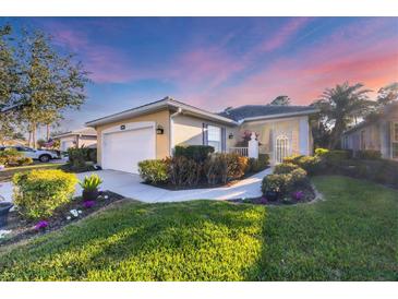 Well-maintained house with a landscaped lawn and a two-car garage at 1584 Monarch Dr, Venice, FL 34293