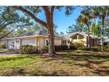 A charming single-story home with a three-car garage, mature landscaping, and a lush lawn at 237 Southampton Ln # 275, Venice, FL 34293