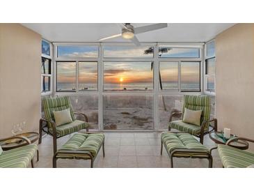 Relaxing sunroom boasts stunning sunset views and comfortable seating at 255 The Esplanade N # 202, Venice, FL 34285