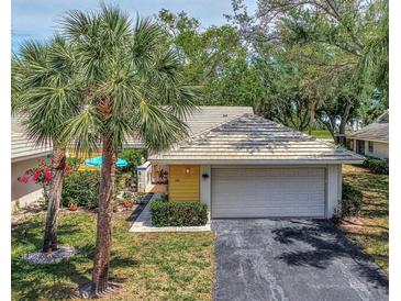 Single story home with attached garage and landscaped yard at 335 Pembroke S Ln # 229, Venice, FL 34293