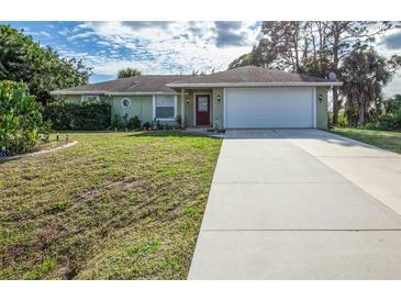 Single-story house with a white garage door and a long driveway at 4695 W Price Blvd, North Port, FL 34286