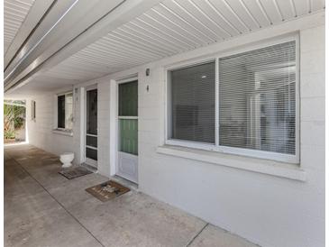 Condo exterior featuring a secure entrance, large window and covered walkway at 525 Manatee Ct # 4, Venice, FL 34285