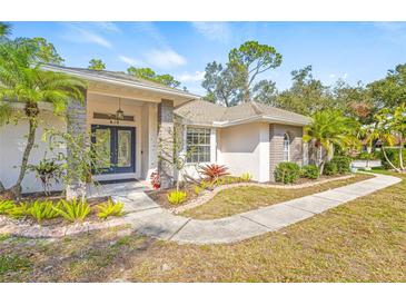 House exterior showcasing landscaping, walkway, and architectural details at 610 Woodview Way, Bradenton, FL 34212