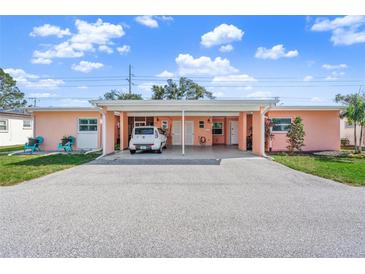 Cute pastel pink exterior with carport and small yard at 6213 Green View Dr # 127, Sarasota, FL 34231