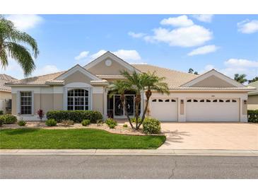 Attractive single-story home with a three-car garage and landscaped lawn at 1010 Grouse Way, Venice, FL 34285