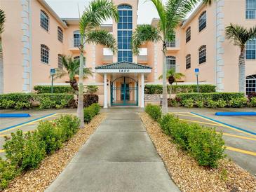 Inviting condo building entrance with lush landscaping and walkway at 1602 Gondola Park Dr # 1602, Venice, FL 34292