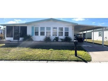 Charming single-story home with a covered carport and well-maintained lawn at 346 Mariner Dr, North Port, FL 34287