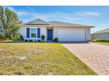 One-story home with a two-car garage and a brick paver driveway at 5550 Eyerly Ter, Port Charlotte, FL 33981