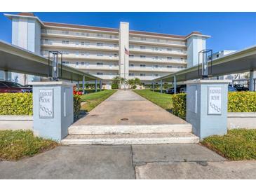 Front entrance of Harbour House, a multi-story building with covered parking at 1000 Tarpon Center Dr # 601, Venice, FL 34285