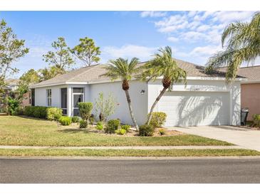 Charming single-story home with well-maintained lawn and landscaping and a two car garage at 11915 Tempest Harbor Loop, Venice, FL 34292