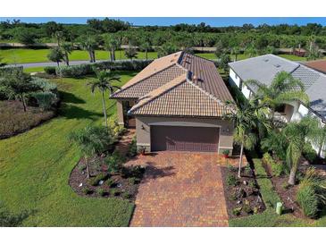 Aerial view of single-story home with tile roof, landscaping, and brick driveway at 13463 Nobilio St, Venice, FL 34293