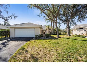 Charming single-story home with a well-maintained lawn and mature landscaping at 174 Southampton S Pl # 345, Venice, FL 34293