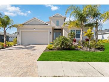 Single-story home with a two-car garage and landscaped front yard at 4309 Renwick Dr, Parrish, FL 34219