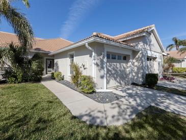 Inviting single-story home featuring a tile roof and well-maintained landscaping at 595 Back Nine Dr, Venice, FL 34285