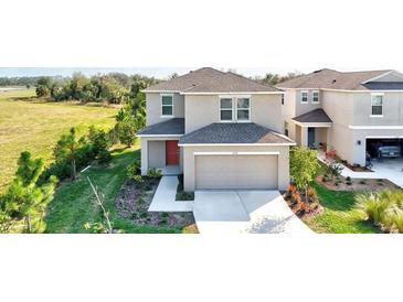 Beautiful two-story home with a manicured lawn and attached two car garage at 6341 Milestone Loop, Palmetto, FL 34221