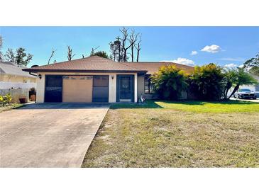 Charming single-story home with a well-maintained lawn and mature trees at 12321 Alta Mira St, North Port, FL 34287