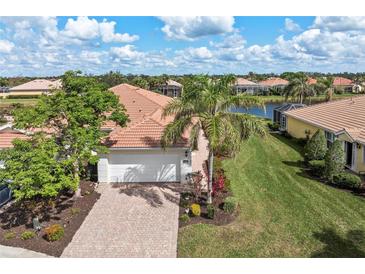 Charming single Gathering home with a two car garage, tile roof, paved driveway and mature landscaping at 13278 Huerta St, Venice, FL 34293