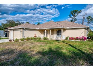Charming single-story home with a well-manicured lawn and inviting front porch at 4332 Big Leaf St, North Port, FL 34286