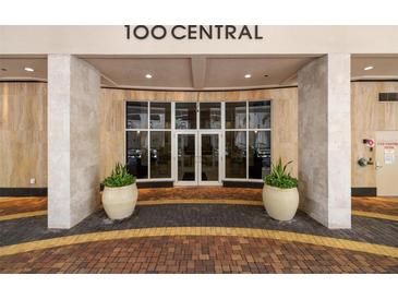 Elegant building entrance with decorative planters and tiled walkway, offering a welcoming first impression at 100 Central Ave # D509, Sarasota, FL 34236