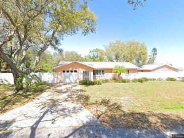 Charming single-story home featuring a spacious front yard and a concrete driveway at 84 Dartmouth Rd, Venice, FL 34293