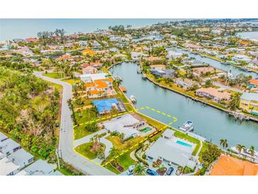 Aerial view of waterfront property with pool and circular driveway at 721 Binnacle Point Dr, Longboat Key, FL 34228