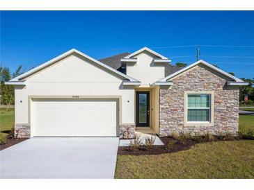 Craftsman style home with stone accents and a two-car garage at 25388 Alicante Dr, Punta Gorda, FL 33955