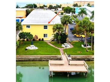 Aerial view of waterfront property with private dock and community pool at 9715 Harrell Ave # 40, Treasure Island, FL 33706