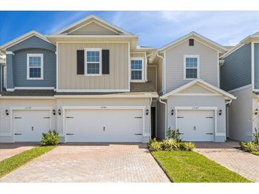 Three-unit townhome building with attached garages and landscaping at 17343 Peregrine Way, Punta Gorda, FL 33982