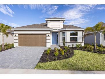 New home exterior with brown garage door and landscaped yard at 9576 Vibrant Lane, Venice, FL 34292