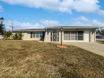 Single-story home with a large yard and attached garage at 272 Algiers Dr, Venice, FL 34293