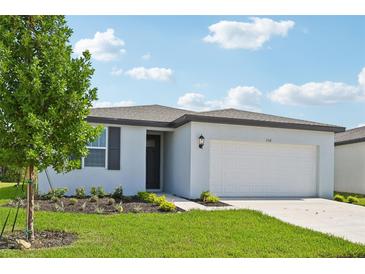 One-story home with white exterior, gray roof, and a two-car garage at 156 Lazy Shore Dr, Nokomis, FL 34275