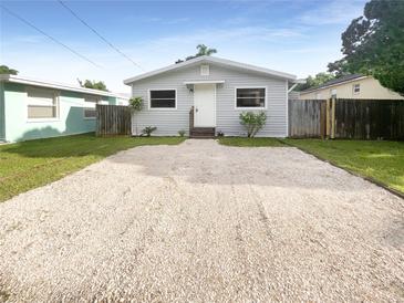 Newly renovated house with a gravel driveway and fenced yard at 1220 36Th W Ave, Bradenton, FL 34205