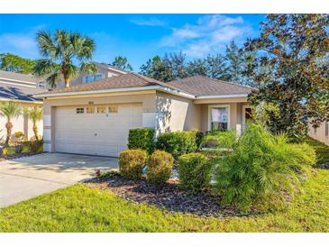 One-story home with attached garage and landscaped front yard at 7851 Tuscany Woods Dr, Tampa, FL 33647