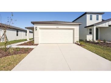 New construction home with a two-car garage and a paved driveway at 14040 Crutchfield Ct, Parrish, FL 34219