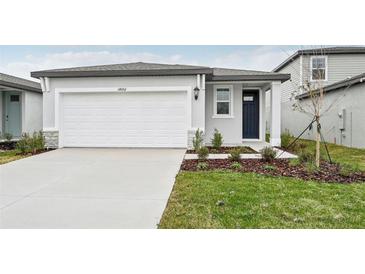 Newly constructed home with attached garage and well-manicured lawn at 14052 Crutchfield Ct, Parrish, FL 34219