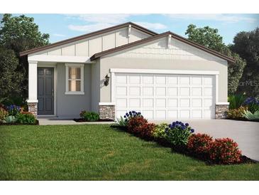 One-story house with gray siding, white garage door, and landscaping at 14036 Crutchfield Ct, Parrish, FL 34219