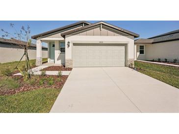 Newly constructed home with attached garage and landscaped front yard at 14036 Crutchfield Ct, Parrish, FL 34219