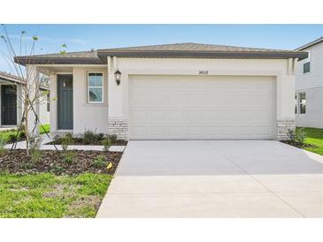 Modern one-story home with attached garage and landscaping at 14037 Crutchfield Ct, Parrish, FL 34219