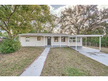 Charming house with a covered carport and well-manicured lawn at 6412 Skyline Ct, Spring Hill, FL 34606